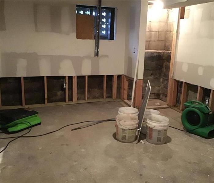 concrete pad, air movers, and flood cuts on the walls showing voids
